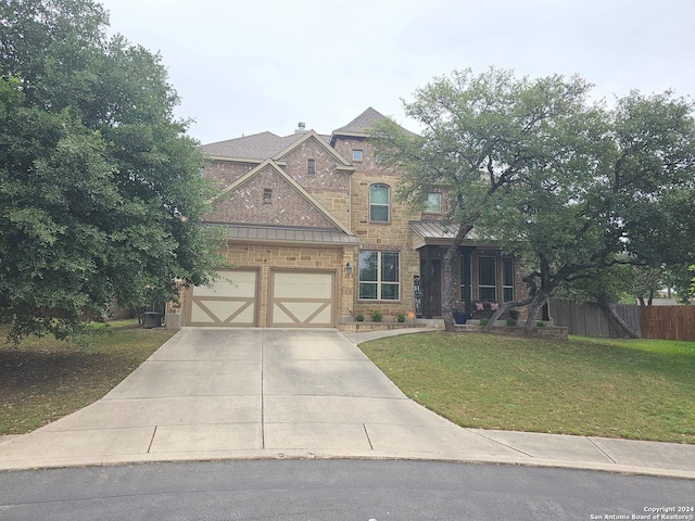 view of front of house featuring a front lawn and a garage