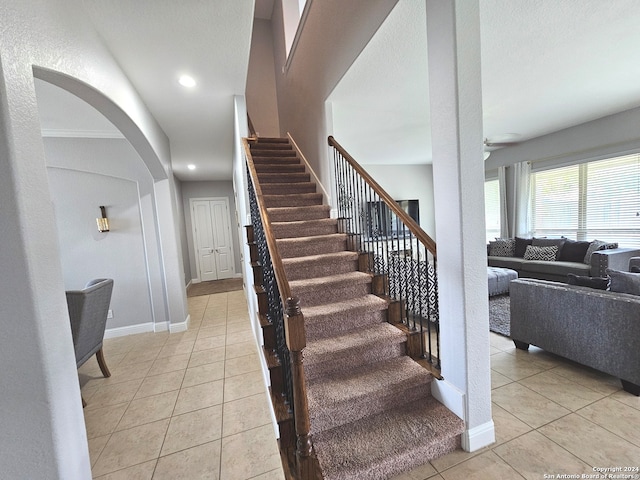 stairs featuring light tile flooring