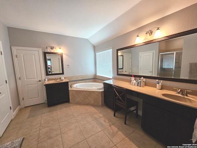 bathroom featuring oversized vanity, a textured ceiling, double sink, tiled bath, and tile floors