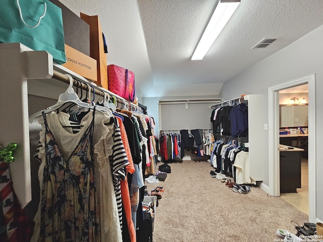 walk in closet with carpet