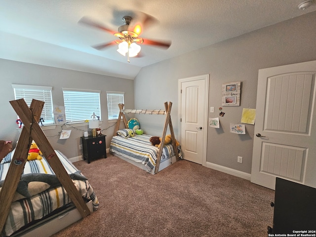 bedroom featuring lofted ceiling, ceiling fan, and carpet