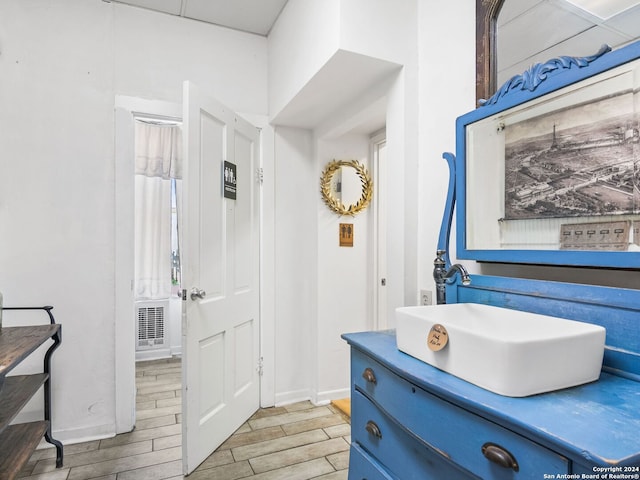 bathroom with wood-type flooring and large vanity