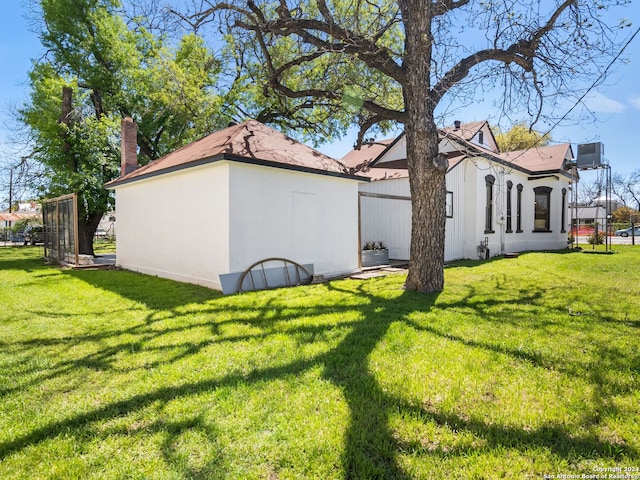 view of side of property with a lawn