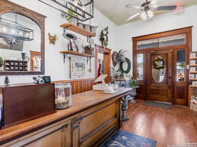 foyer with dark hardwood / wood-style floors, ceiling fan, and vaulted ceiling