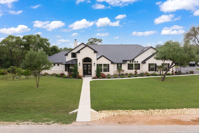 modern farmhouse style home with a front yard