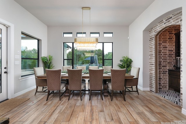 dining area featuring a chandelier, plenty of natural light, and light hardwood / wood-style flooring