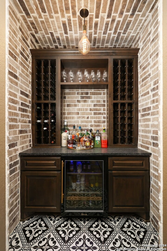 interior space with wine cooler, tile floors, indoor bar, and brick ceiling