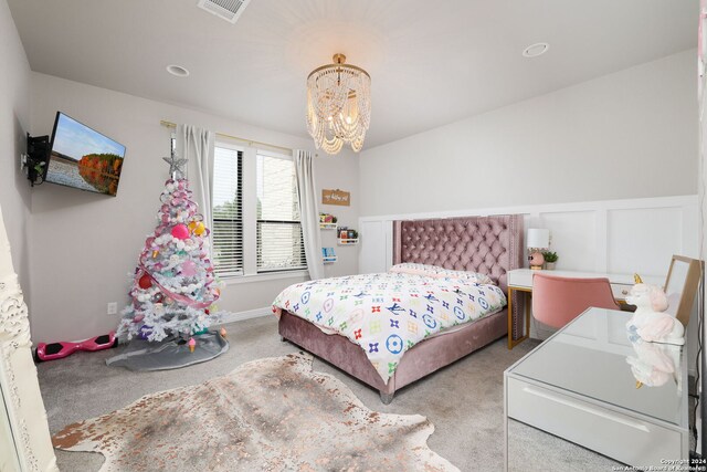 bedroom with a chandelier and carpet floors