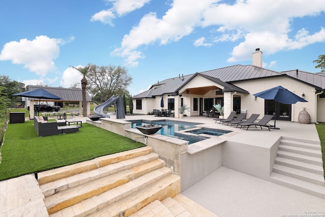 view of pool with a patio area, a yard, a water slide, and an outdoor living space