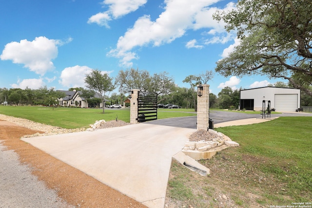 view of property's community with a yard and an outdoor structure