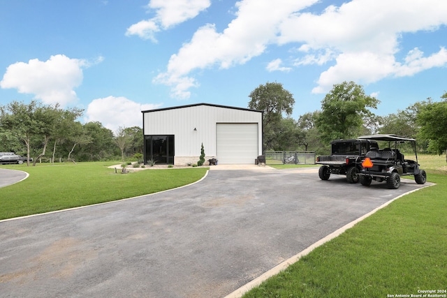 view of outdoor structure with a garage and a lawn