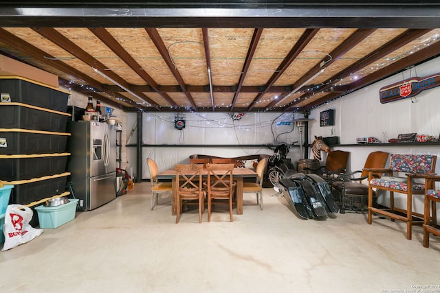 garage with stainless steel fridge with ice dispenser