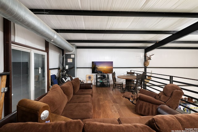 living room with beamed ceiling and hardwood / wood-style floors