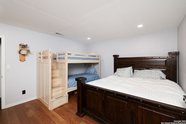 bedroom with dark wood-type flooring