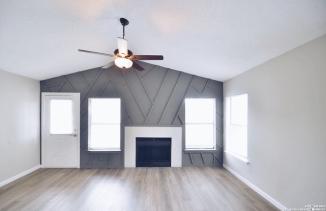 unfurnished living room featuring vaulted ceiling, ceiling fan, and hardwood / wood-style floors