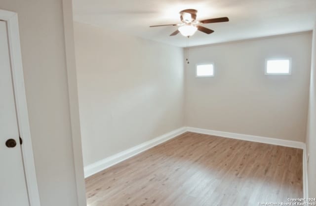 spare room with ceiling fan and light wood-type flooring