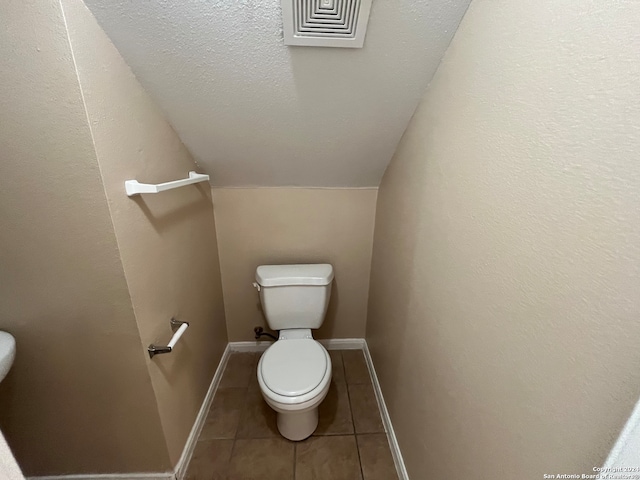 bathroom featuring toilet and tile floors