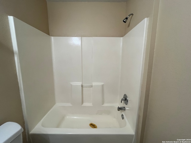 bathroom with toilet and shower / bathing tub combination