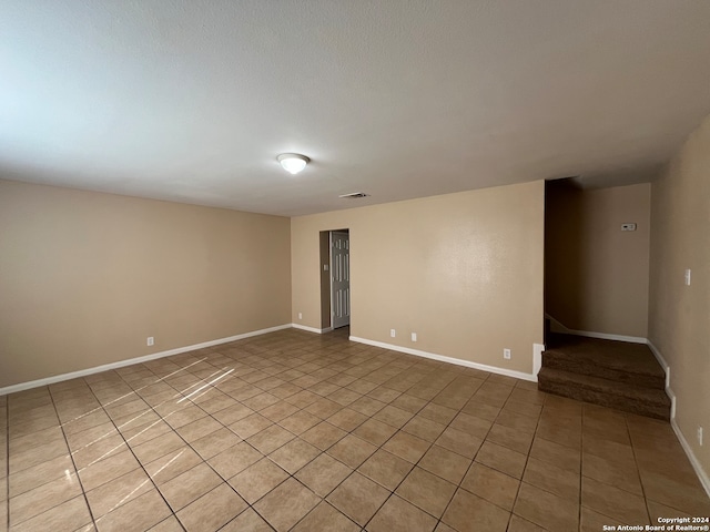 spare room with light tile floors