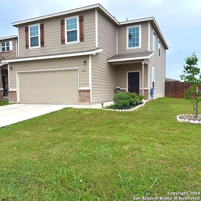 view of front of home featuring a garage and a front lawn