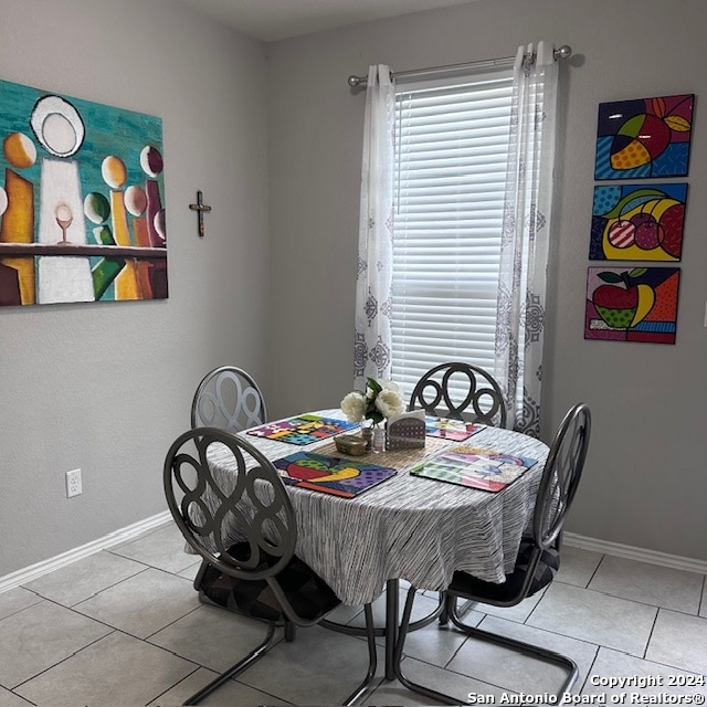 dining area featuring light tile flooring