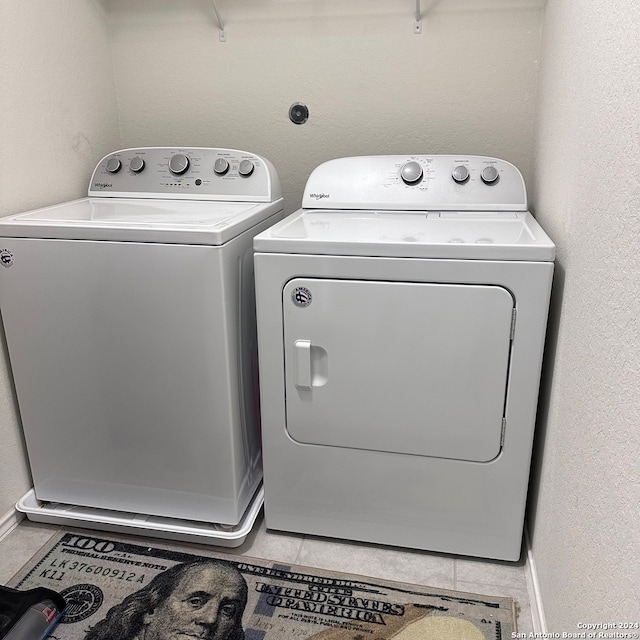 washroom with washer and dryer and tile floors