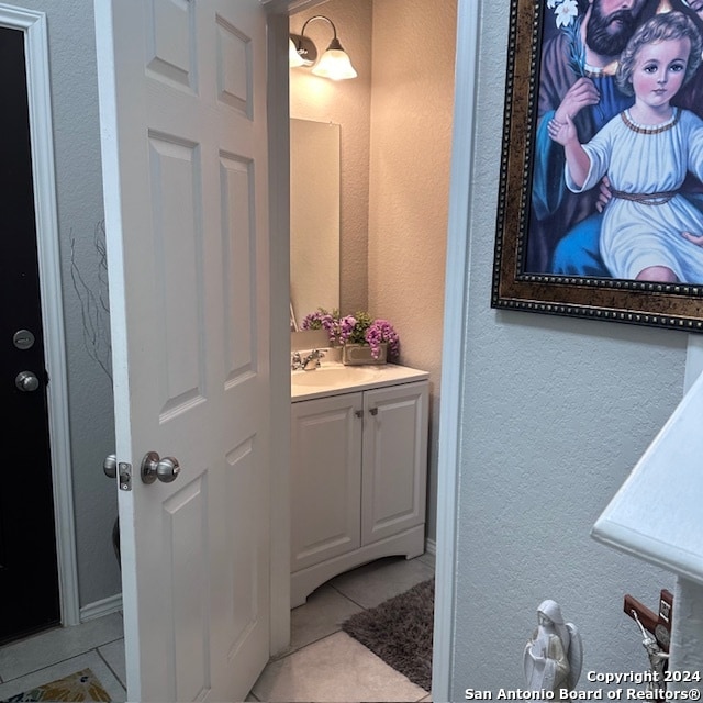 bathroom with vanity and tile floors