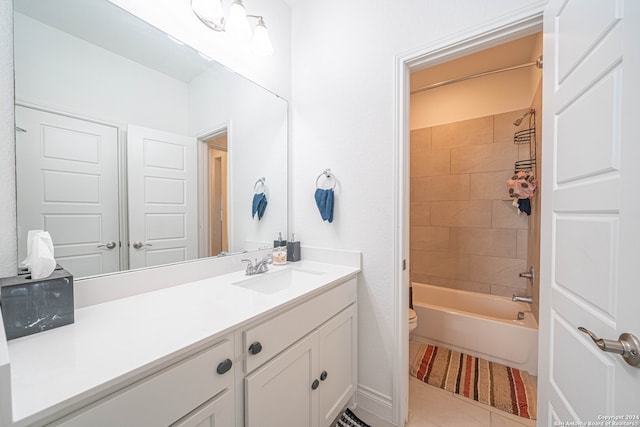 full bathroom featuring tile flooring, tiled shower / bath, vanity, and toilet