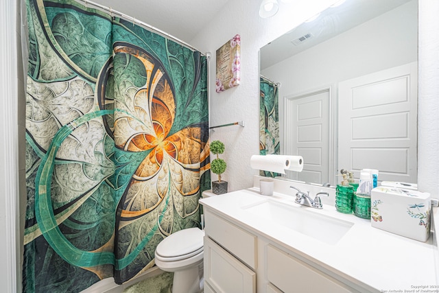 bathroom with toilet and vanity