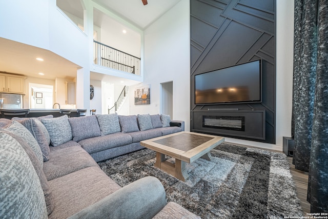 living room with dark hardwood / wood-style flooring, a high ceiling, and sink