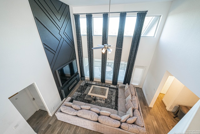 foyer entrance featuring dark wood-type flooring, ceiling fan, and a high ceiling