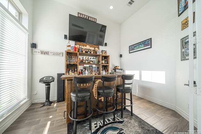 bar featuring hardwood / wood-style flooring