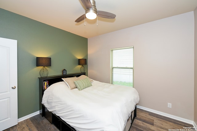 bedroom featuring ceiling fan and dark wood-type flooring