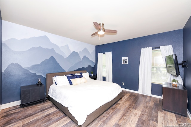 bedroom with ceiling fan, hardwood / wood-style floors, and multiple windows