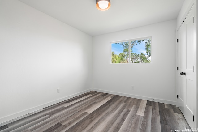 empty room with dark hardwood / wood-style floors