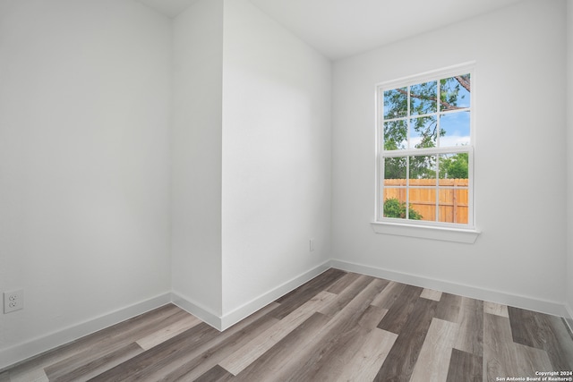 spare room featuring wood-type flooring