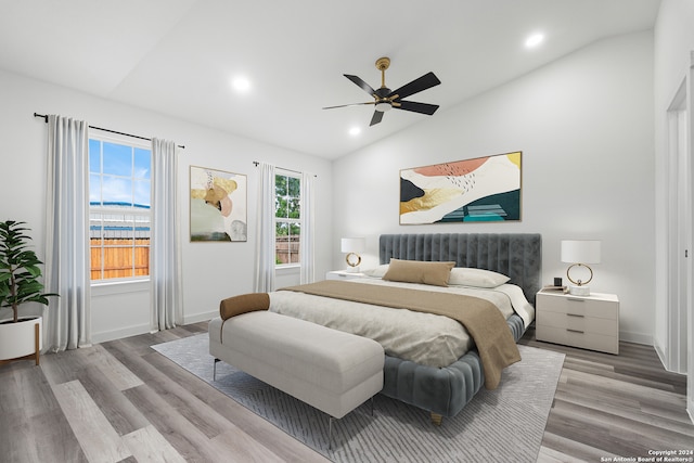 bedroom featuring ceiling fan, hardwood / wood-style floors, and lofted ceiling