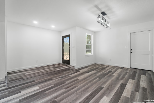 spare room with dark hardwood / wood-style flooring