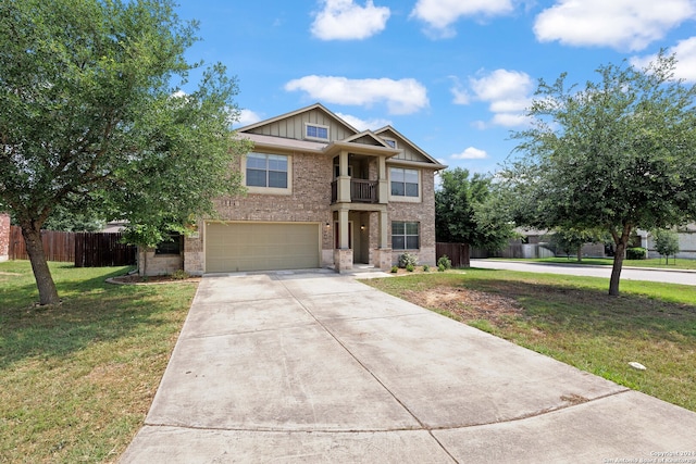 view of front of house with a front lawn, a balcony, and a garage