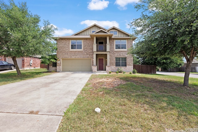 craftsman-style home with a front lawn, a balcony, and a garage