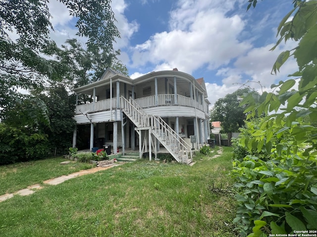 rear view of property with a lawn