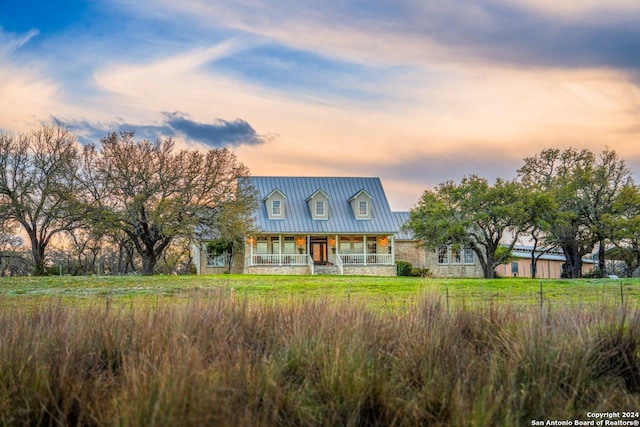 new england style home featuring covered porch