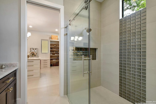 bathroom featuring walk in shower, tile patterned floors, and vanity