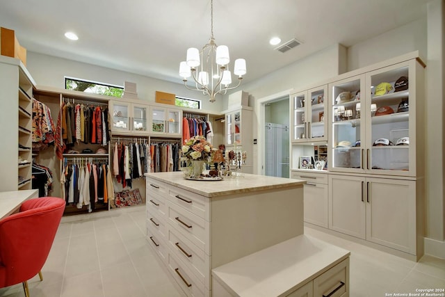 spacious closet featuring an inviting chandelier