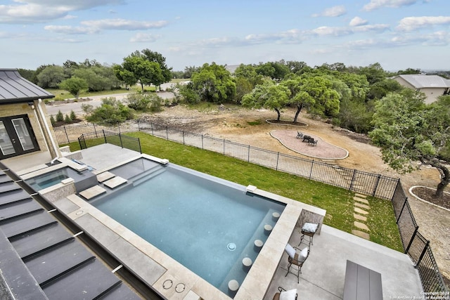 view of swimming pool featuring an in ground hot tub and a yard