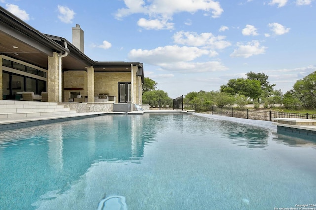 view of swimming pool with pool water feature