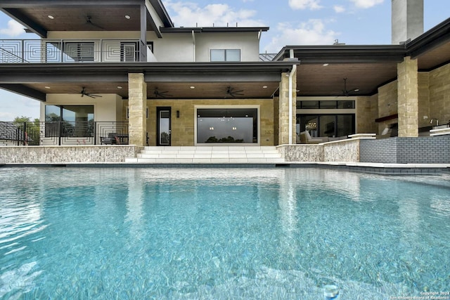 view of pool with ceiling fan and a bar