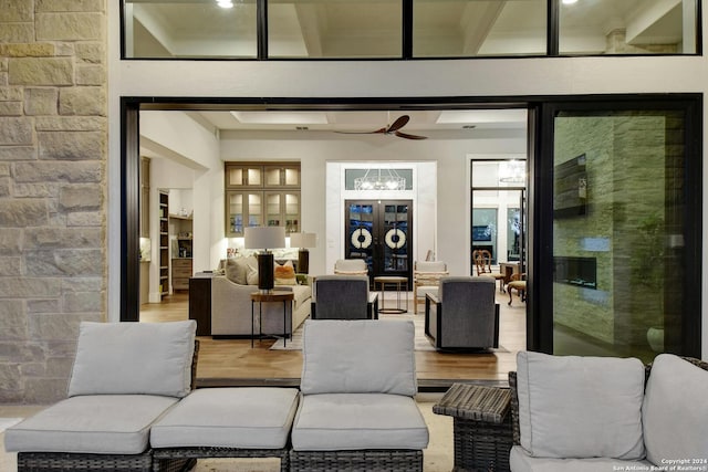 living room featuring a high ceiling, ceiling fan, and hardwood / wood-style floors