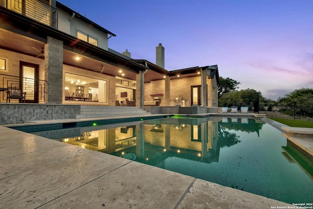 view of pool at dusk