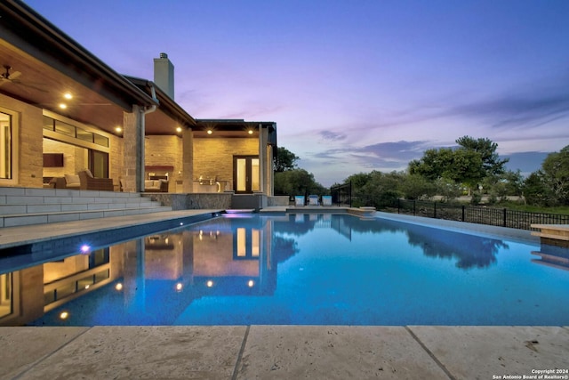 view of pool at dusk